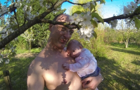 Papa me montre les fleurs dans les arbres du jardin